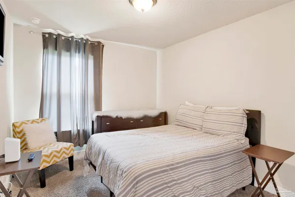 a bedroom with a bed and a window