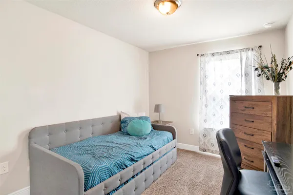 a bedroom with a bed and with furniture