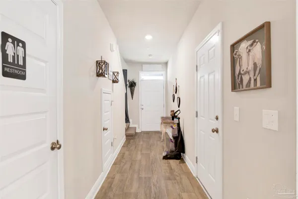 a view of a hallway with wooden floor and closet