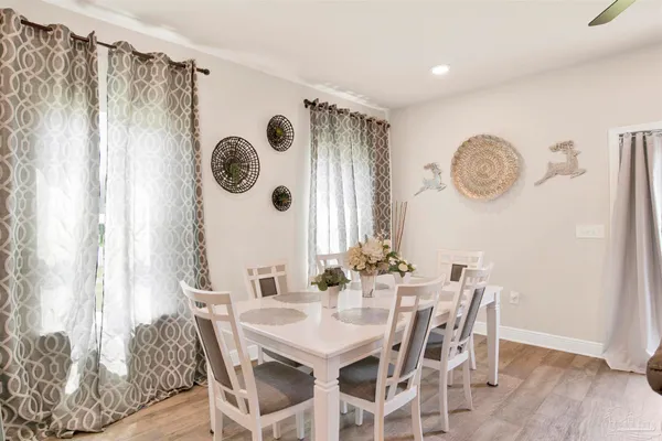 a view of a dining area with furniture and wooden floor