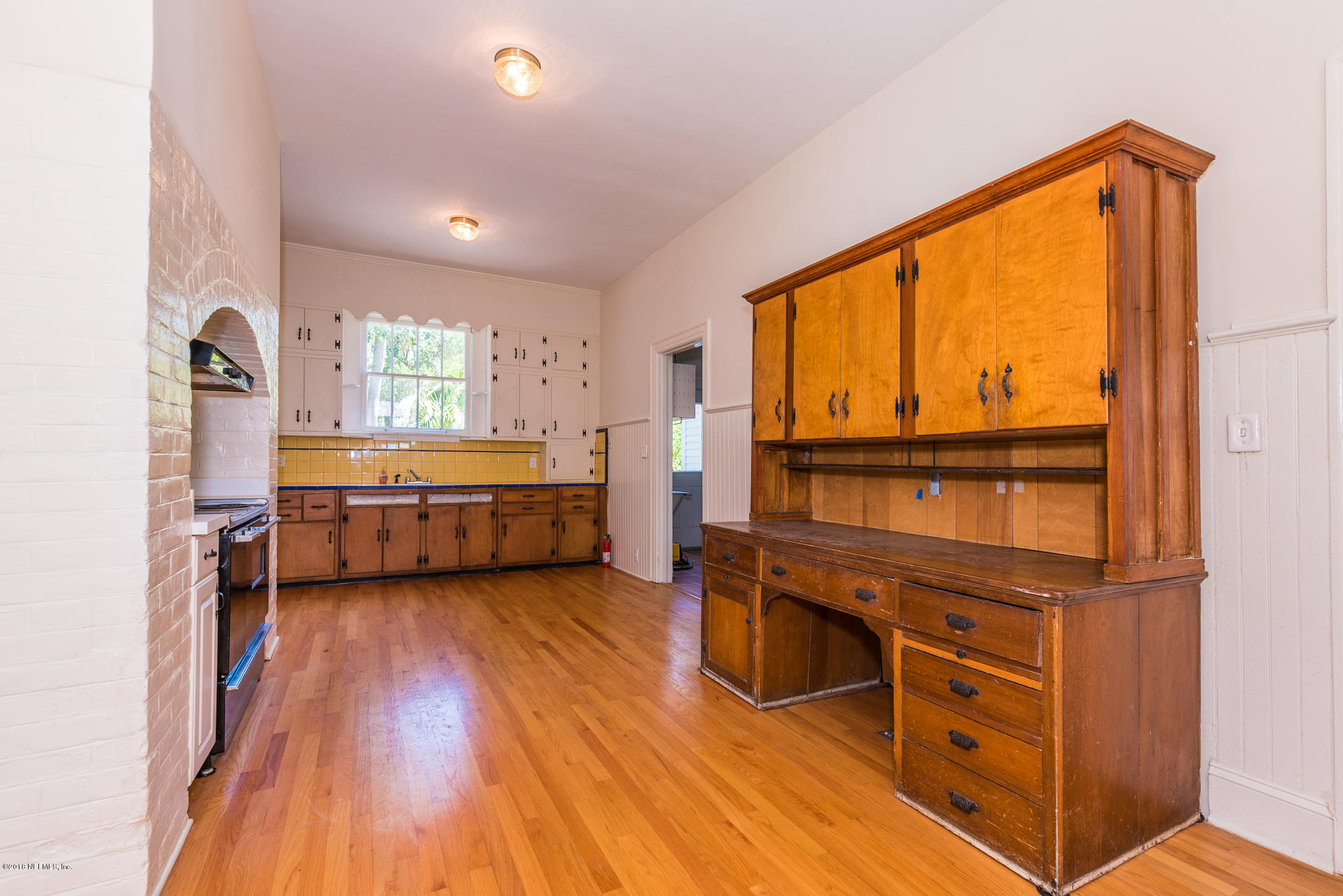 27 Riberia Street St. Augustine, FL 32084 - Photo 14 of 46 a view of a bedroom with cabinet a ceiling fan and windows
