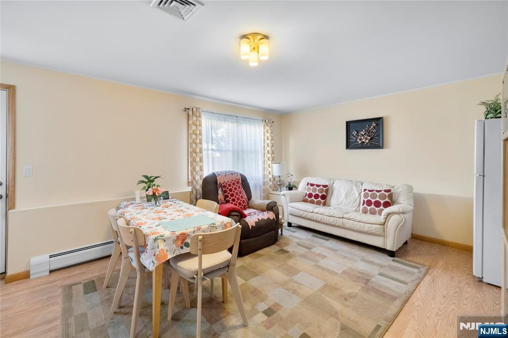 66 Roehrs Drive Wallington, NJ 07057 - Photo 27 of 37 a living room with furniture and painting on the wall