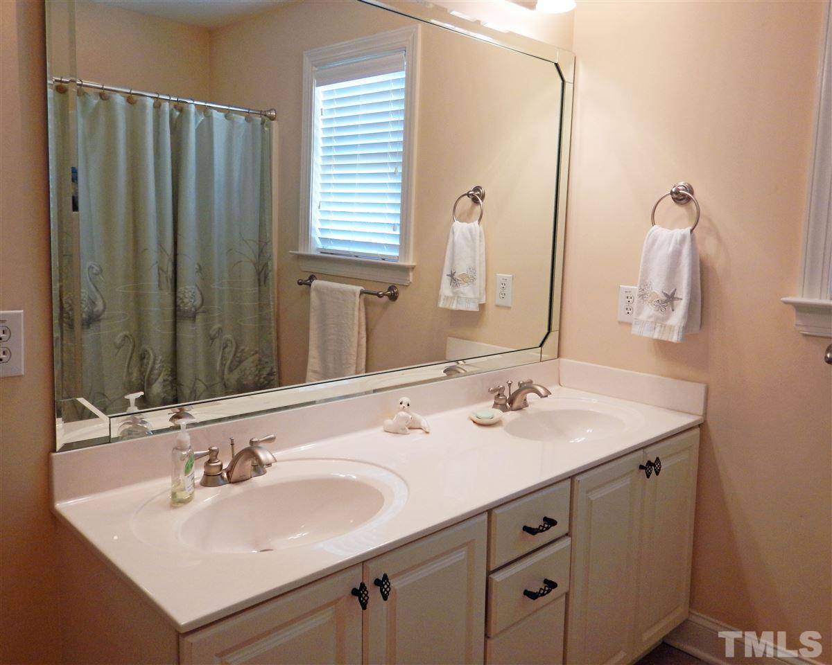 636 Competition Road Raleigh, NC 27603 - Photo 14 of 25 a bathroom with a sink and a mirror