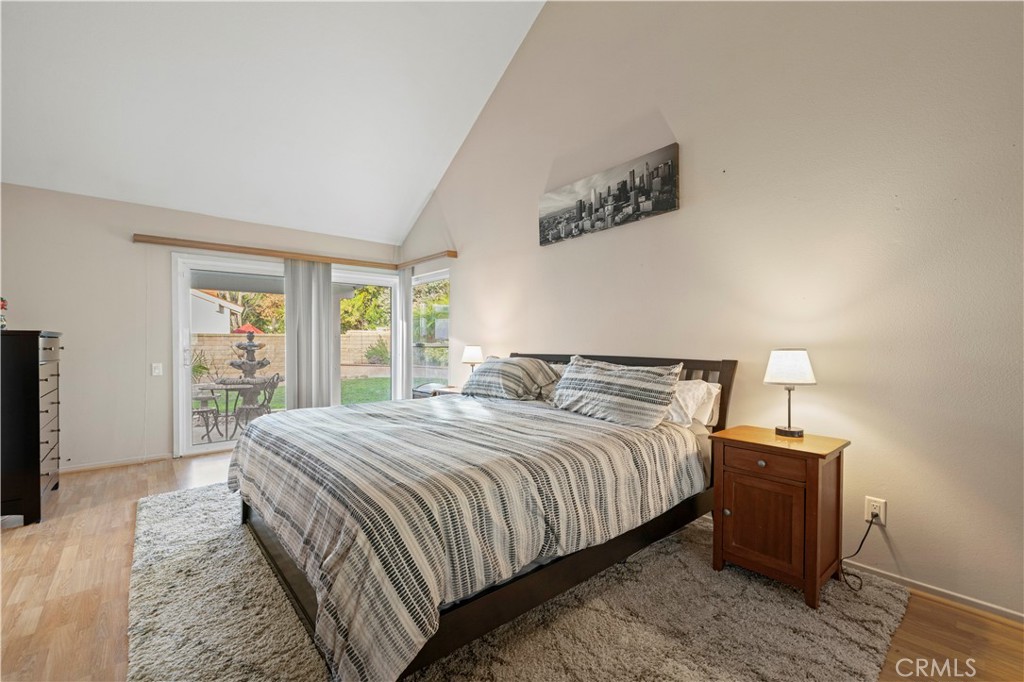 23716 Rotunda Road Valencia, CA 91355 - Photo 18 of 39 a bedroom with a bed and wooden floor