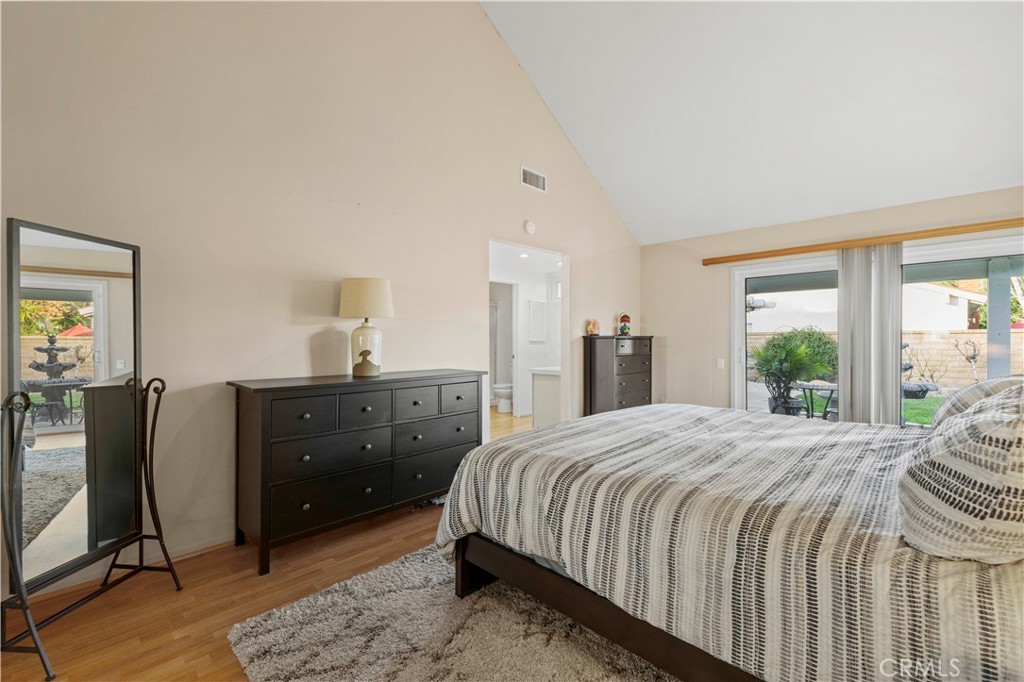 23716 Rotunda Road Valencia, CA 91355 - Photo 19 of 39 a bedroom with a bed and wooden floor