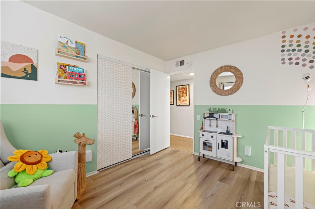 23716 Rotunda Road Valencia, CA 91355 - Photo 26 of 39 a view of a storage & utility room with toys and wooden floor
