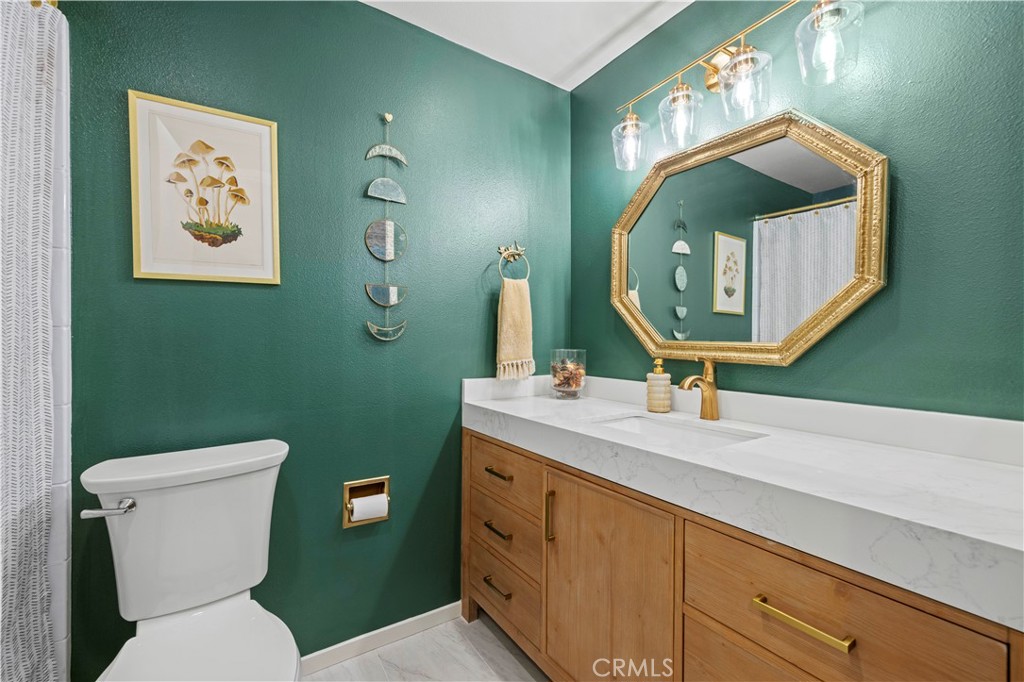 23716 Rotunda Road Valencia, CA 91355 - Photo 29 of 39 a bathroom with a toilet sink and mirror