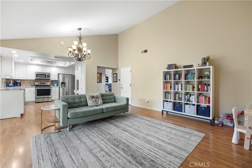 23716 Rotunda Road Valencia, CA 91355 - Photo 33 of 39 a living room with furniture and a wooden floor