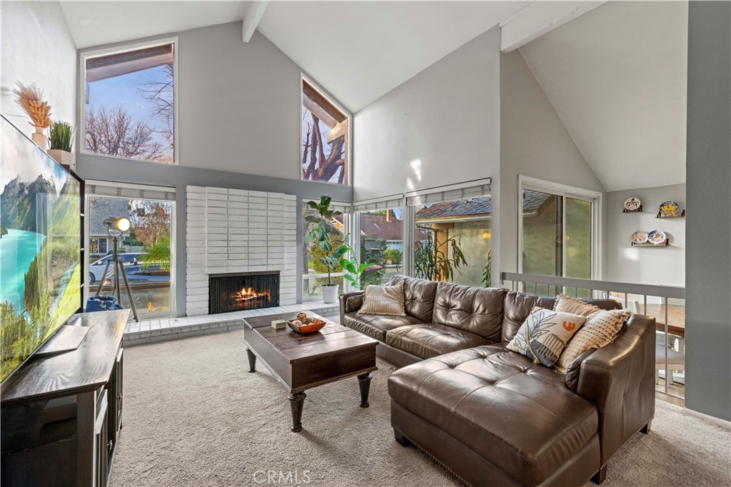23716 Rotunda Road Valencia, CA 91355 - Photo 7 of 39 a living room with furniture a fireplace and a flat screen tv