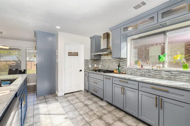 a kitchen with stainless steel appliances granite countertop a refrigerator and a sink