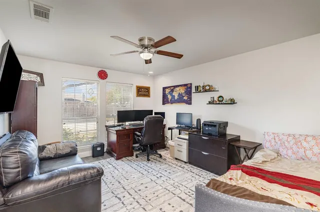 a view of a livingroom with workspace and a window