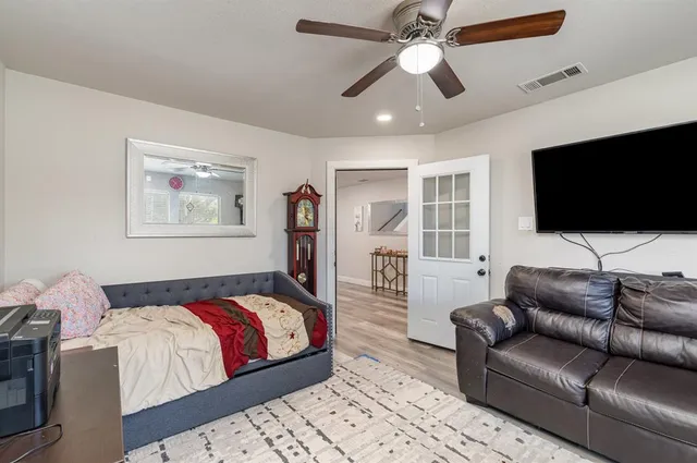 a living room with a couch a rug and a flat screen tv