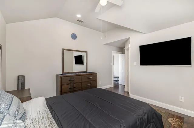a bedroom with a bed and a flat screen tv
