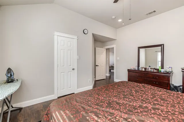 a bed room with a bed and a mirror