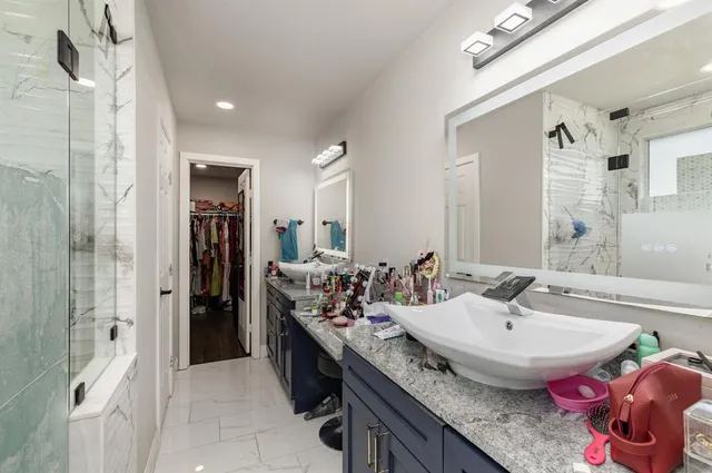 a bathroom with a granite countertop sink and a mirror