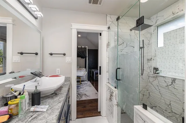 a bathroom with a tub shower and toilet