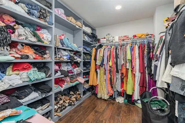 a view of walk in closet with clothes