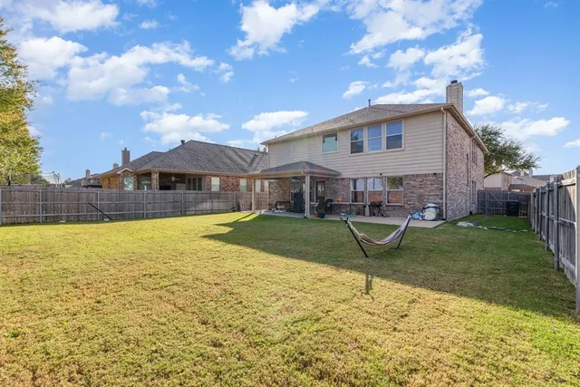 a view of a house with swimming pool and a yard