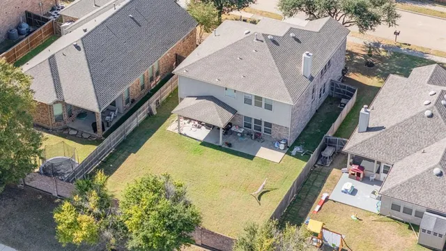 an aerial view of residential houses with outdoor space