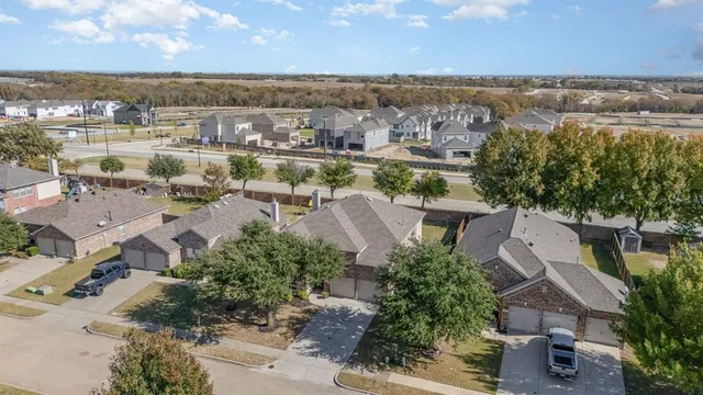 an aerial view of a city with lots of residential buildings ocean and mountain view in back