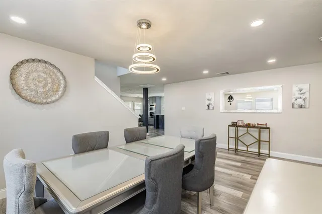 a view of a dining room with furniture and wooden floor