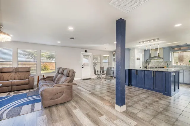 a living room with furniture and kitchen view