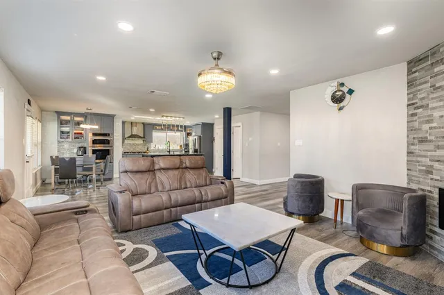 a living room with furniture and a chandelier