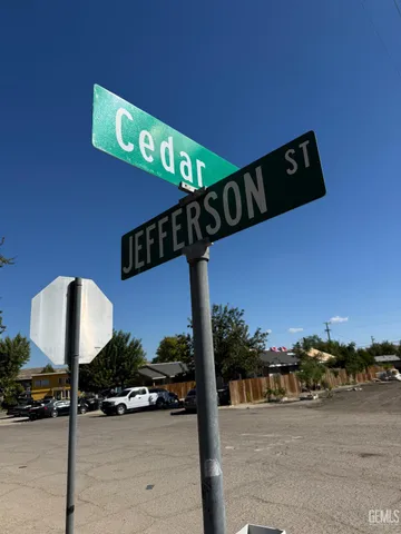 a view of a house with a small yard next to a road
