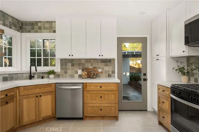 a kitchen with a stove top oven sink and cabinets