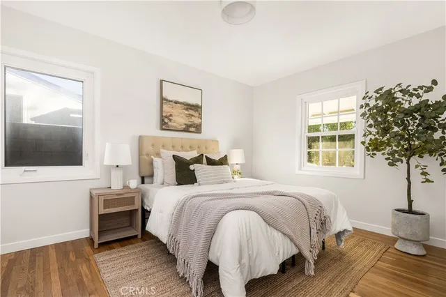 a bedroom with a bed and a potted plant