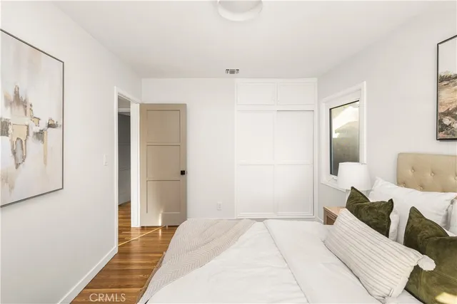 a bedroom with a bed and a mirror