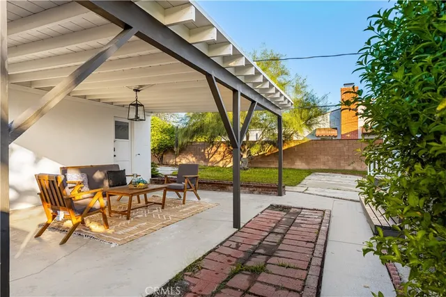 a view of a patio with table and chairs and potted plants
