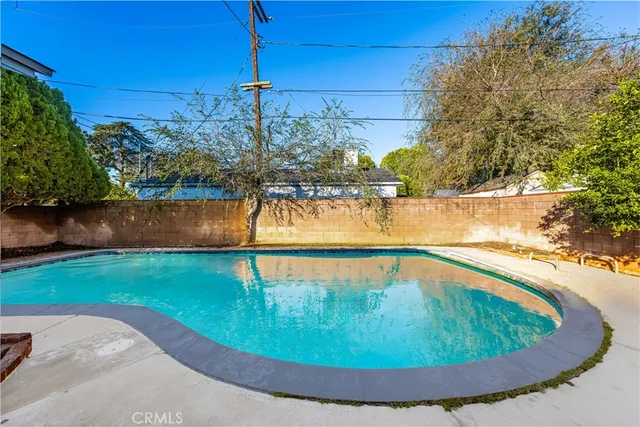 a view of a swimming pool with a yard
