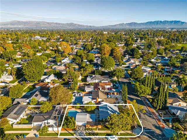 a view of swimming pool in front of house with trees