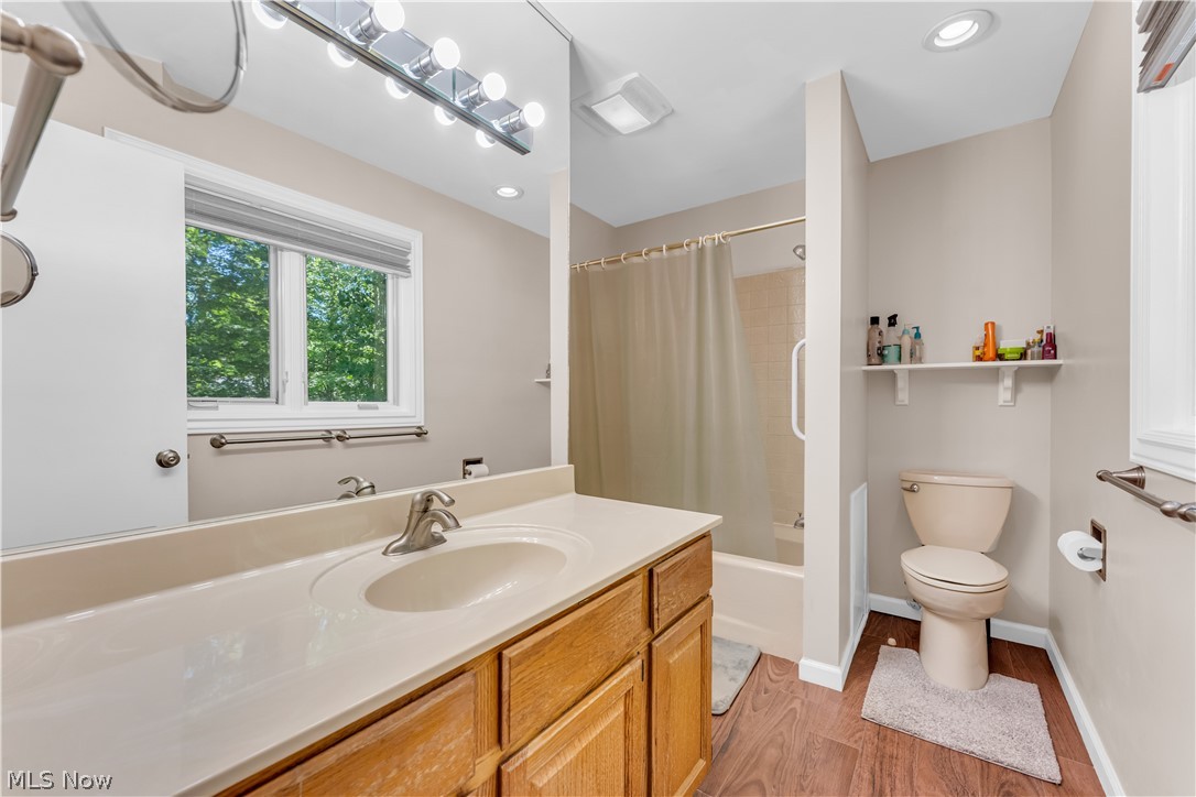 6821 Thornapple Road Gates Mills, OH 44040 - Photo 26 of 42 Bathroom featuring a single vanity with a light-colored countertop, wood-finish cabinetry, and a large mirror