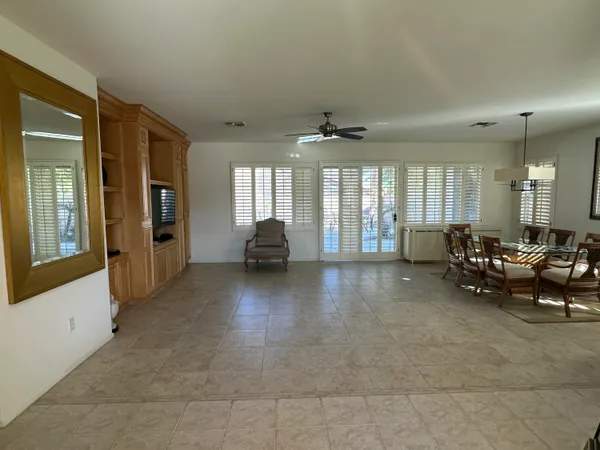 a view of a livingroom with furniture and a large window