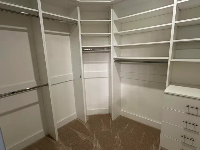 a view of an empty walk in closet