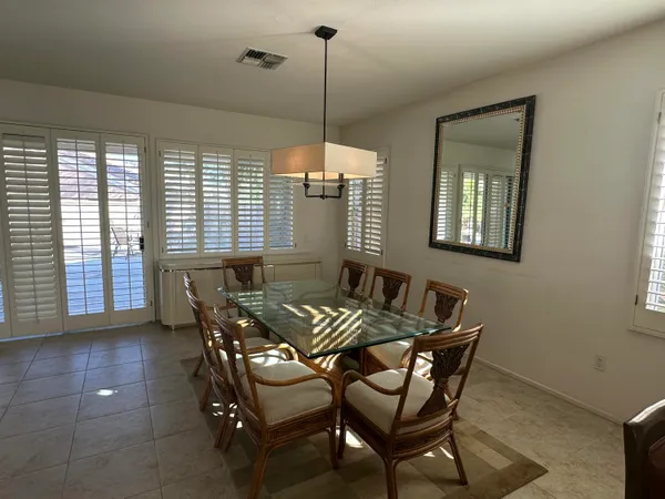 a dining room with furniture and window