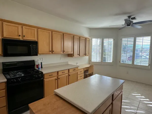 a kitchen with a stove a sink and a microwave