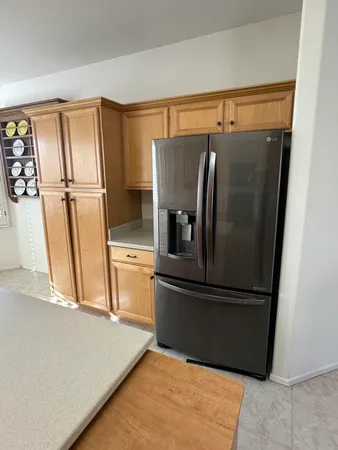 a kitchen with metallic refrigerator freezer and a dishwasher
