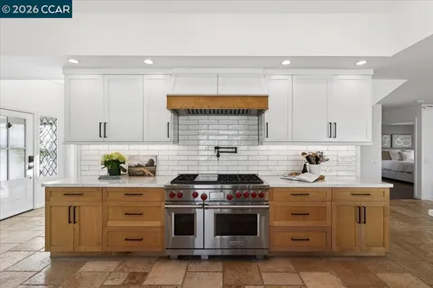 a kitchen with stainless steel appliances a stove and cabinets