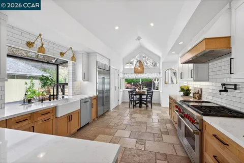 a kitchen with stainless steel appliances kitchen island granite countertop a sink and cabinets
