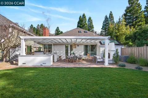 a view of a patio with table and chairs