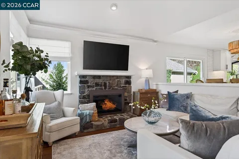 a living room with furniture a fireplace and a flat screen tv