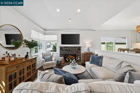 a living room with furniture fireplace and a flat screen tv