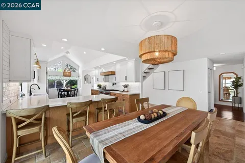 a view of a dining room with furniture and a chandelier