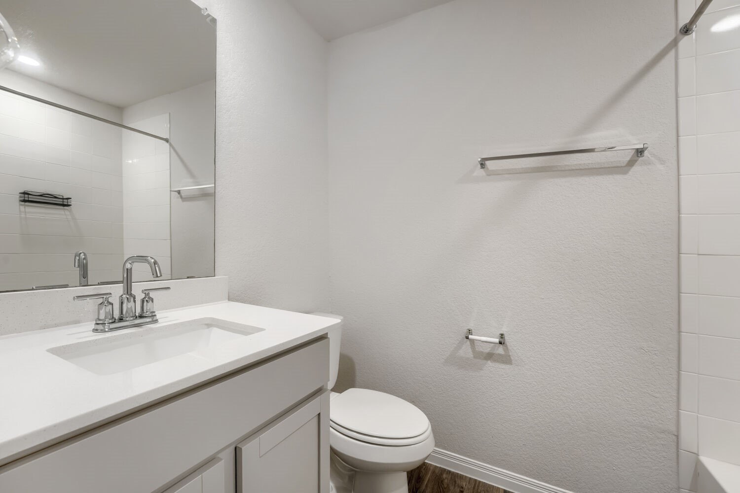 13507 Howser Trace Manor, TX 78653 - Photo 21 of 28 A well-appointed bathroom features a single vanity, modern fixtures, and sleek white tiling.