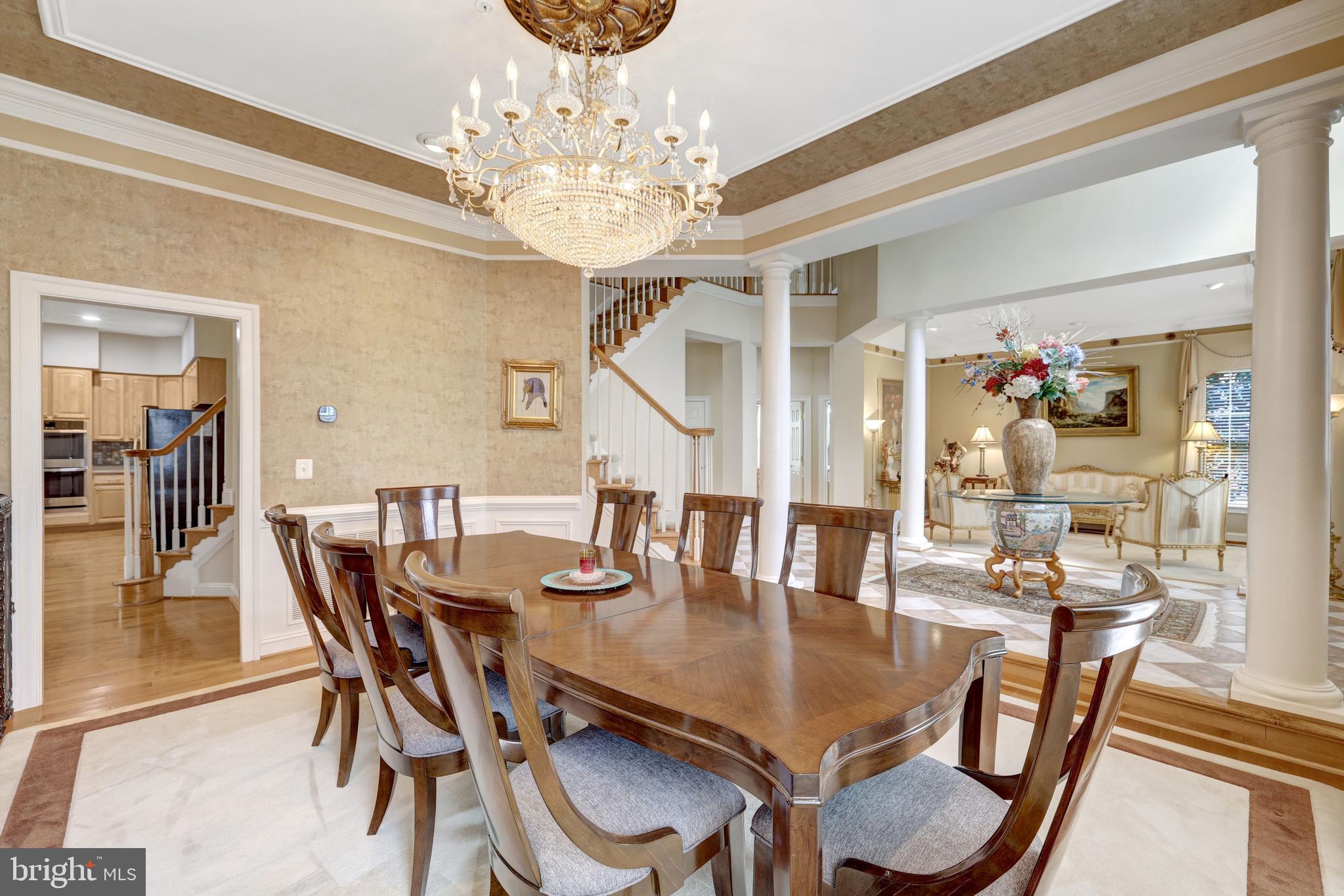 20443 Cliftons Point Street Sterling, VA 20165 - Photo 6 of 37 a dining room with furniture a chandelier and wooden floor