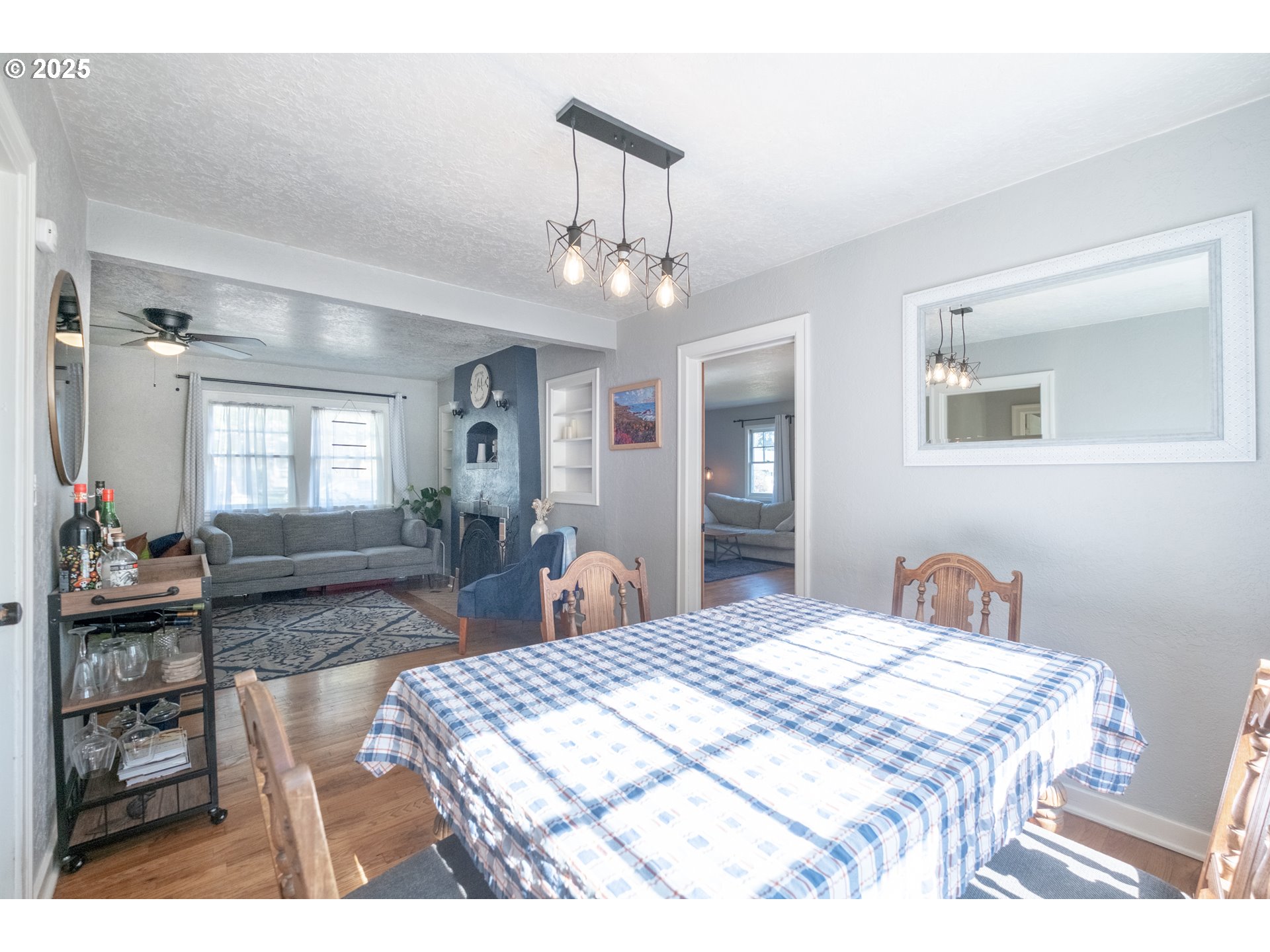 906 Southwest 11th Avenue Albany, OR 97321 - Photo 14 of 48 a bedroom with a bed a chandelier and mirror