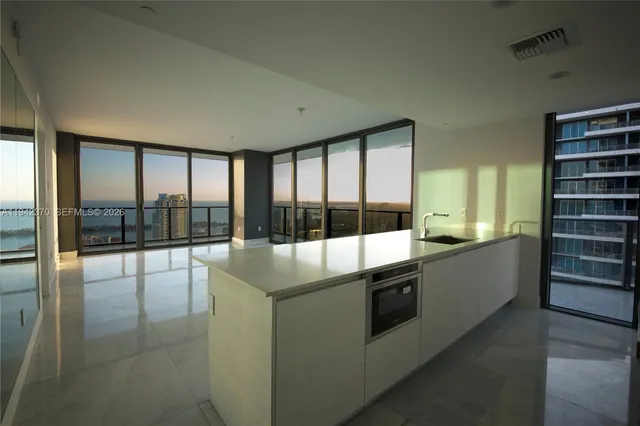 a large kitchen with a large window